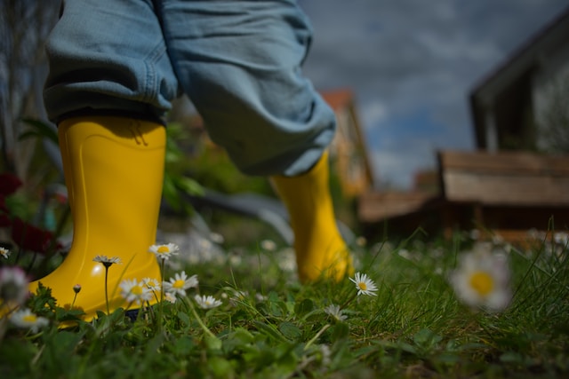 child gardening in gumboots